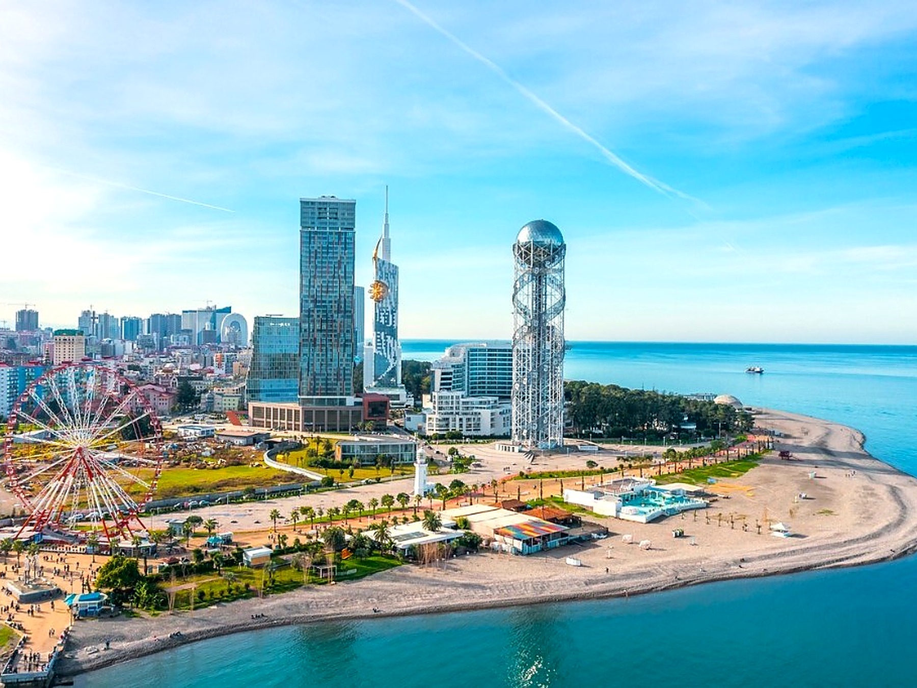 Aerial view of Batumi coastline — beach, parks and the Black Sea on a clear summer day