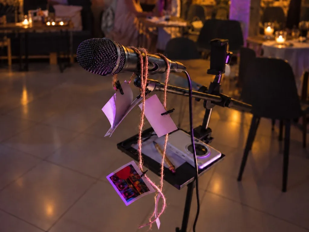 Microphone on a stand with poem pages at a poetry evening